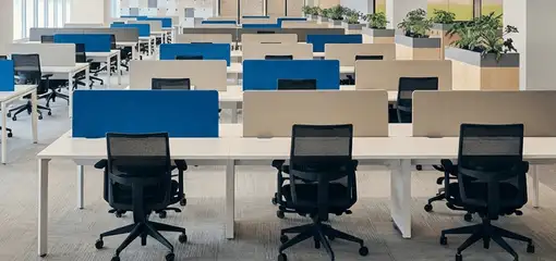 Modern open-plan office space featuring clean workstations, ergonomic chairs, and sanitized carpets provided by professional office cleaning services in South Bend, IN.