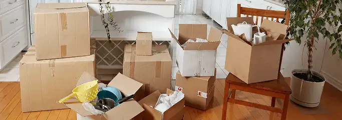 Packed moving boxes and household items in a kitchen before move-out or move-in cleaning, South Bend, IN.